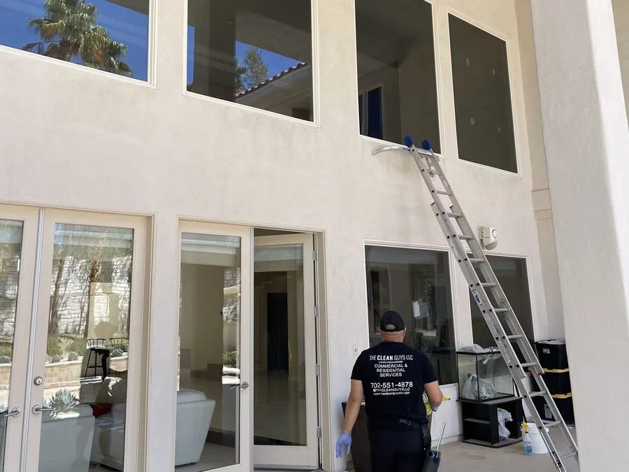 Two-story window cleaning with ladder on luxury Las Vegas estate
