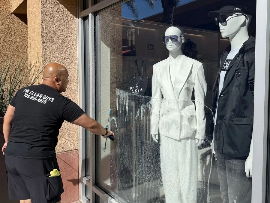 The Clean Guys cleaning Plein luxury storefront window Las Vegas