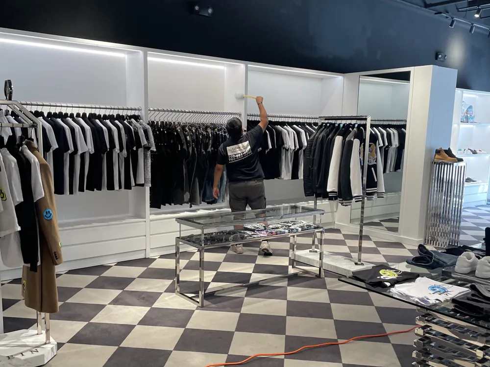 The Clean Guys cleaning displays and shelving at a Las Vegas retail clothing boutique